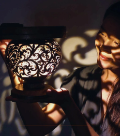 Woman holding a glowing Women's Lantern solar light